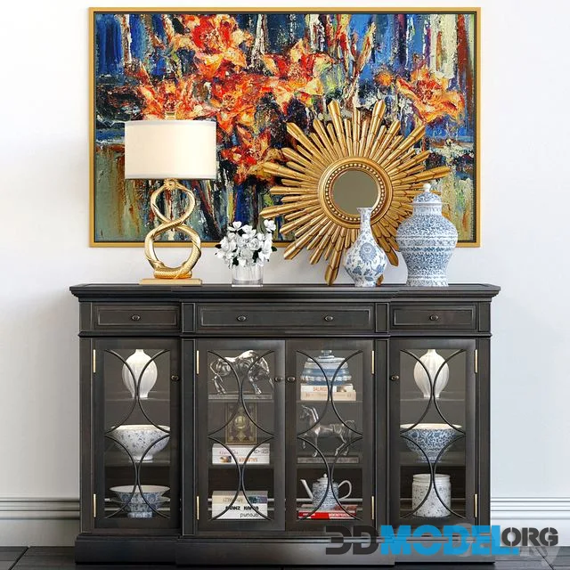 A chest of drawers with a collection of decor, a lamp and a set of sculptures