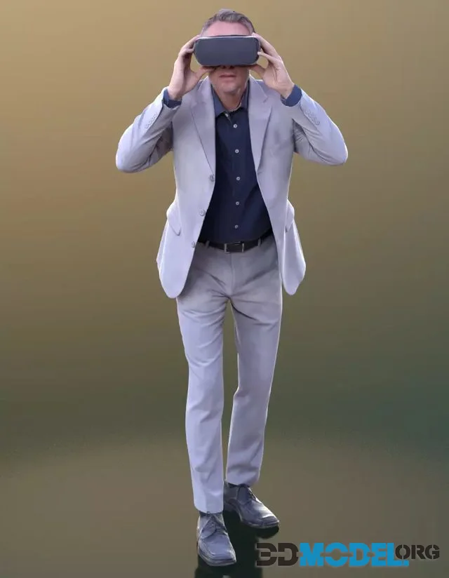 A man Carlos in a light-colored suit looks into a VR helmet